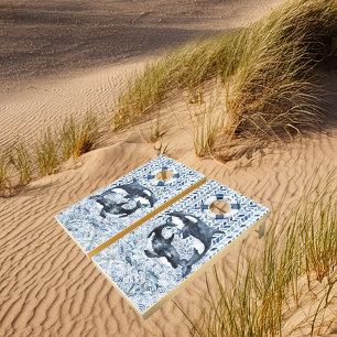 Orcas playing with a lifebuoy cornhole set