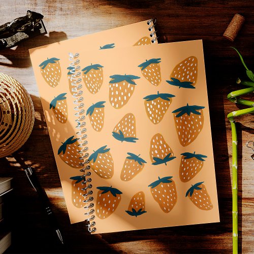 Organic summer strawberries in orange notebook