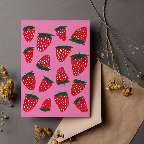 Organic summer strawberries red on pink background postcard