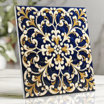 Ornate Blue and Gold Scrollwork Ceramic Tile<br><div class="desc">This beautifully ornate tile showcases intricate scrollwork patterns in rich navy blue, accented by golden and white details for a timeless, luxurious aesthetic. The symmetrical design is perfect for creating an elegant backsplash, statement wall, or decorative focal point in your home. With its classic appeal and detailed craftsmanship, this tile...</div>