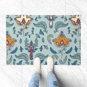 Ornate floral pattern on a pale blue background doormat
