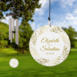Ornate Gold Border White Wedding Couples Names Wind Chime<br><div class="desc">These beautiful wind chimes are perfect as a wedding or anniversary gift, or they can be used as decorations and serve as a beautiful memento of your special day. The design features an ornate golden border with curls and swirls with the names of the couple and wedding date in the...</div>