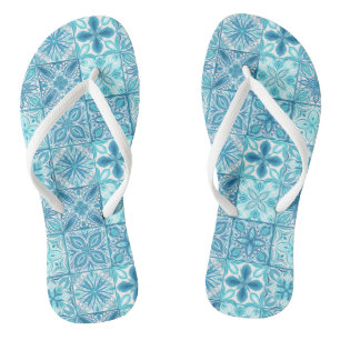 Ornate tiles in blue and white flip flops