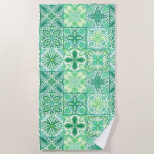Ornate tiles in green and white beach towel