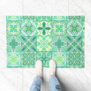 Ornate tiles in green and white doormat