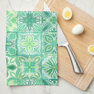 Ornate tiles in green and white kitchen towel
