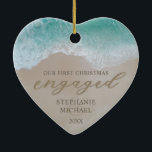 Our First Christmas Engaged Beach Ceramic Ornament<br><div class="desc">Beach 1st christmas engaged ornament featuring a tropical sandy shoreline,  turquoise blue sea,  the cute saying "our first christmas engaged" partly written in the sand,  your names,  and the year.</div>