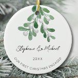 Our First Christmas Engaged Mistletoe Ceramic Ornament<br><div class="desc">Celebrate your first Christmas as an engaged couple with this stylish ceramic ornament. 
It is decorated with watercolor mistletoe and elegant script typography.
Easily customizable.
Use the Design Tool to change the text size,  style,  or color.
Original Watercolor © Michele Davies.</div>
