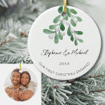 Our First Christmas Engaged Mistletoe Photo Ceramic Ornament<br><div class="desc">Celebrate your first Christmas as an engaged couple with this stylish photo ceramic ornament. 
It is decorated with watercolor mistletoe and elegant script typography.
Easily customizable with your names,  date,  and photo.
Use the Design Tool to change the text size,  style,  or color.
Original Watercolor © Michele Davies.</div>