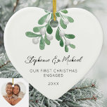 Our First Christmas Engaged Mistletoe Photo Ceramic Ornament<br><div class="desc">Celebrate your first Christmas as an engaged couple with this heart-shaped photo ceramic ornament. 
It is decorated with watercolor mistletoe and elegant script typography.
Easily customizable with your names,  date,  and photo.
Original Watercolor © Michele Davies.</div>