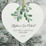 Our First Christmas Engaged Mistletoe Photo Heart  Ceramic Ornament<br><div class="desc">Celebrate your first Christmas as an engaged couple with this heart-shaped photo ceramic ornament. 
It is decorated with watercolor mistletoe and elegant script typography.
Easily customizable with your names and date.
Original Watercolor © Michele Davies.</div>
