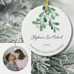 Our First Christmas Married Mistletoe Photo Ceramic Ornament<br><div class="desc">Celebrate your first Christmas as a married couple with this stylish photo ceramic ornament. 
It is decorated with watercolor mistletoe and elegant script typography.
Easily customizable. with your names,  date,  and photo.
Use the Design Tool to change the text size,  style,  or color.
Original Watercolor © Michele Davies.</div>