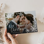 Our First Christmas Snowflake Newlywed Photo Holiday Card<br><div class="desc">Make a stunning statement this holiday season with this stylish full-bleed 1 photo holiday card that says "Our First Christmas"; and featuring watercolor textured snowflakes and typography with an authentic brushed look. You may customize the background of the back by using the customization options available. The back has a snowflake...</div>