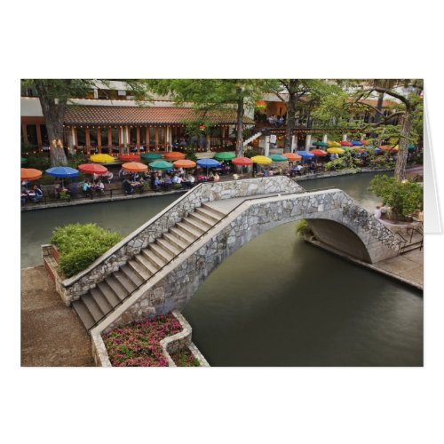 Outdoor cafe along River Walk and bridge over 2