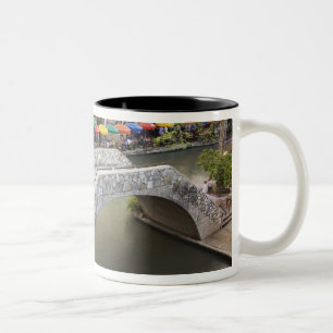 Outdoor cafe along River Walk and bridge over 2 Two-Tone Coffee Mug