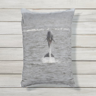 Outdoor pillow with dolphins jumping