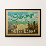 Outer Banks Jigsaw Puzzle Beach Vintage Travel<br><div class="desc">This Greetings From Outer Banks vintage postcard design features a sandy beach with a beautiful turquoise ocean water and above the sea,  a blue sky with billowy white clouds. In vintage travels style.</div>