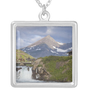 Packers lead string of horses over bridge above silver plated necklace