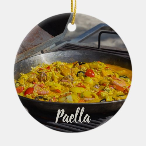Paella is cooked on a grill gift for chef ceramic ornament