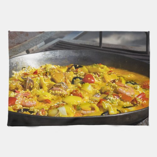 Paella is cooked on a grill towel