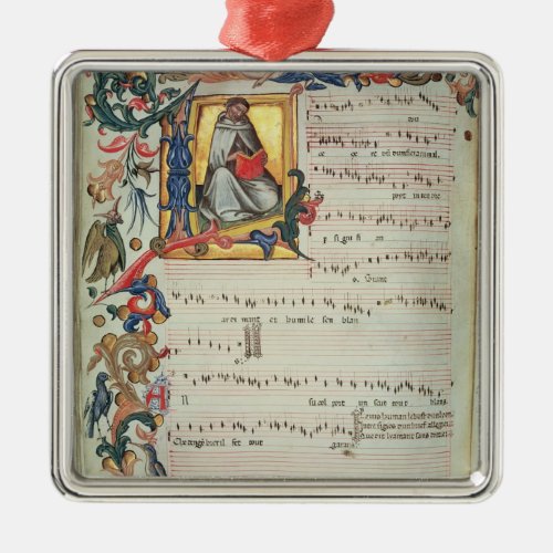 Page of musical notation with a historiated metal ornament