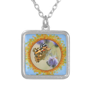 Painted lady butterfly feeding in frame of leaves silver plated necklace
