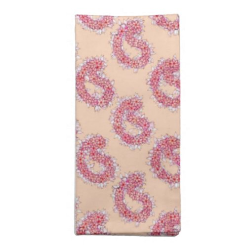 Paisley pattern in flowers coral pink on a peach napkin