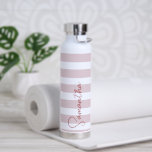 Pale Pink and White Stripes Personalized Water Bottle<br><div class="desc">Stay stylish and hydrated with this personalized custom metal easy-to-clean insulated water bottle, perfect for the gym, office, or on-the-go! Featuring your name in elegant handwritten script over a soft pale pink and white striped background, this minimalistic design is both chic and functional. This well-made bottle keeps drinks cool during...</div>