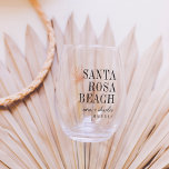 Palm Frond Destination Wedding Favor Stemless Wine Glass<br><div class="desc">Impress your destination wedding guests with these chic and modern personalized stemless wine glass wedding favors. Design features a light tropical peach palm frond illustration with your wedding destination aligned at the right (shown with Santa Rosa Beach) in classic serif lettering. Add your names beneath in handwritten cursive script, as...</div>