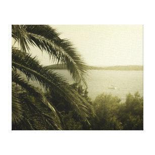 Palm leaves with blurry ship in background canvas print
