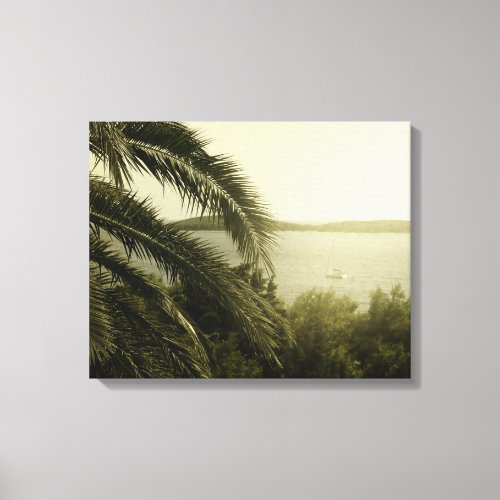 Palm leaves with blurry ship in background canvas print