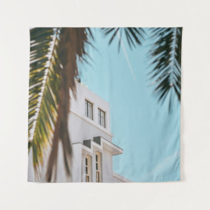Palm tree near white concrete building tapestry