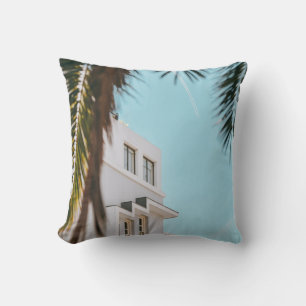 Palm tree near white concrete building throw pillow