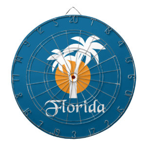 Palms and orange sun dartboard with darts