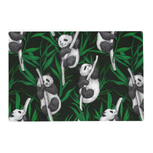 Panda cubs on dark green placemat