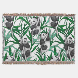 Panda cubs on throw blanket