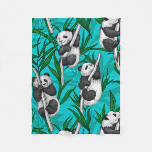 Panda cubs on turquoise fleece blanket