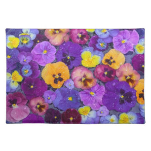 Pansy flowers floating in bird bath with dew cloth placemat