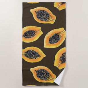 Papaya slices on dark brown beach towel