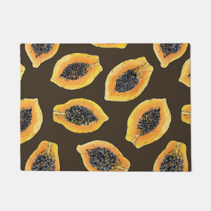 Papaya slices on dark brown doormat