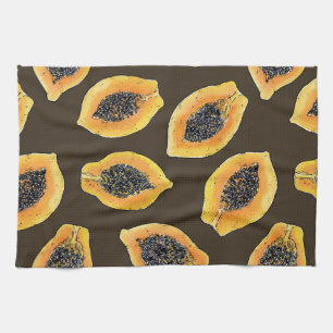 Papaya slices on dark brown kitchen towel