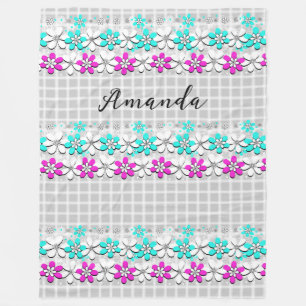 Paper neon flowers on a gray-white checkered fleece blanket