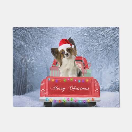 Papillon Dog in Snow sitting in Christmas Truck Doormat