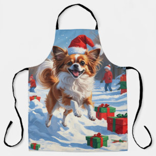 Papillon Dog Running in Snow with Christmas Hat Apron