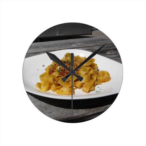 Pappardelle with mushrooms on rustic wooden table round clock
