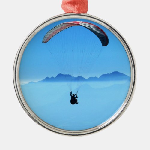 Paraglider on blue background with mountains metal ornament