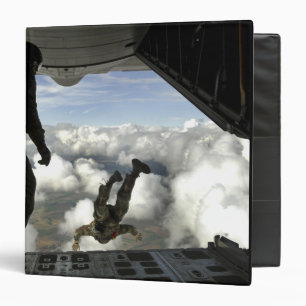 Pararescuemen jump out the back of a C-130 Binder