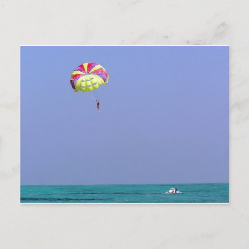 Parasailing over the blue water postcard