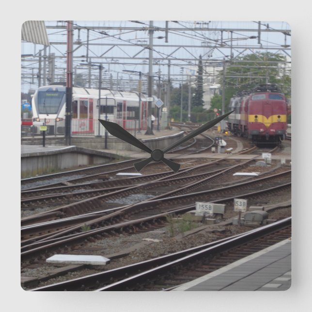 Passenger Trains arriving at railway station clock (Front)