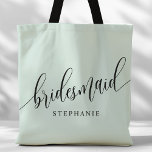 Pastel Mint Bridesmaid Modern Script Tote Bag<br><div class="desc">Show your appreciation to your bridal party with this stylish pastel mint green bridesmaid tote bag. Featuring modern script and customizable with your bridesmaid's name, this tote bag is both practical and elegant. The soft color and chic design make it perfect for carrying wedding day essentials or everyday items. This...</div>